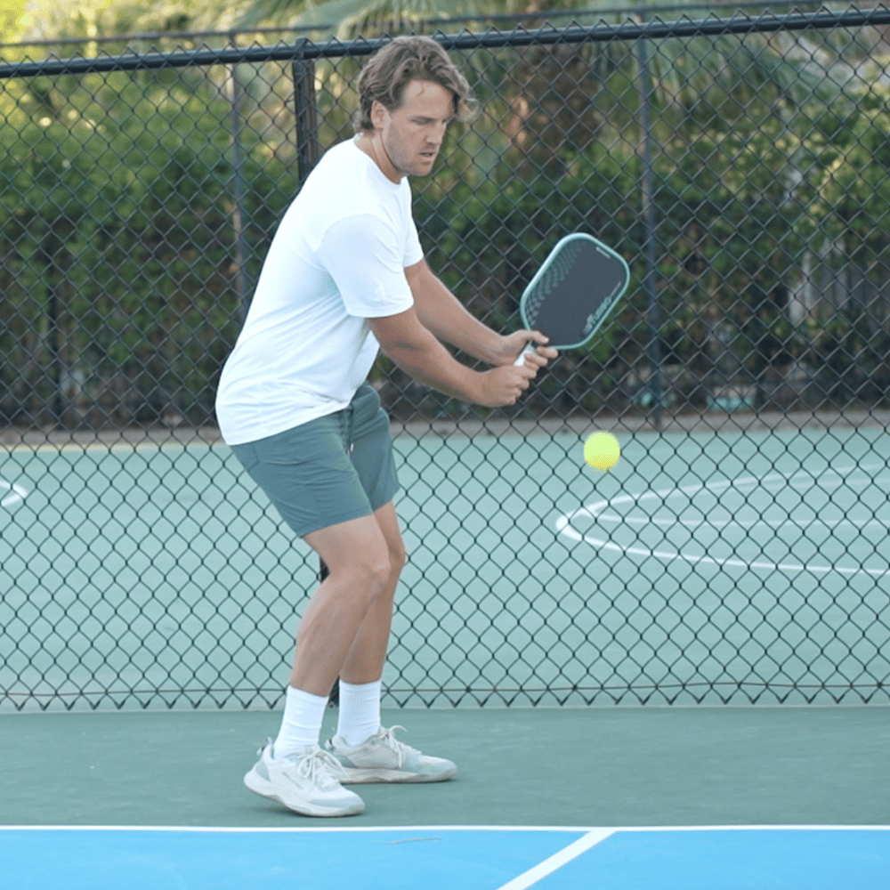 Austin Hardy hitting on a pickleball court during paddle break-in