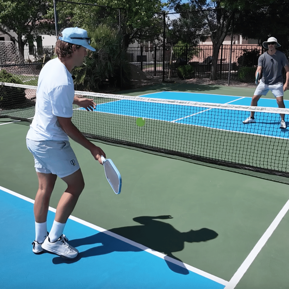 Austin Hardy drilling with a partner on a pickleball court